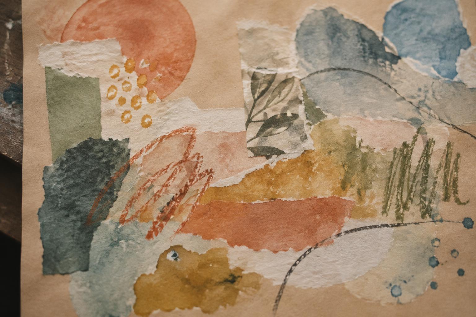 Hand-painted paper circles gathered across a communal worktable